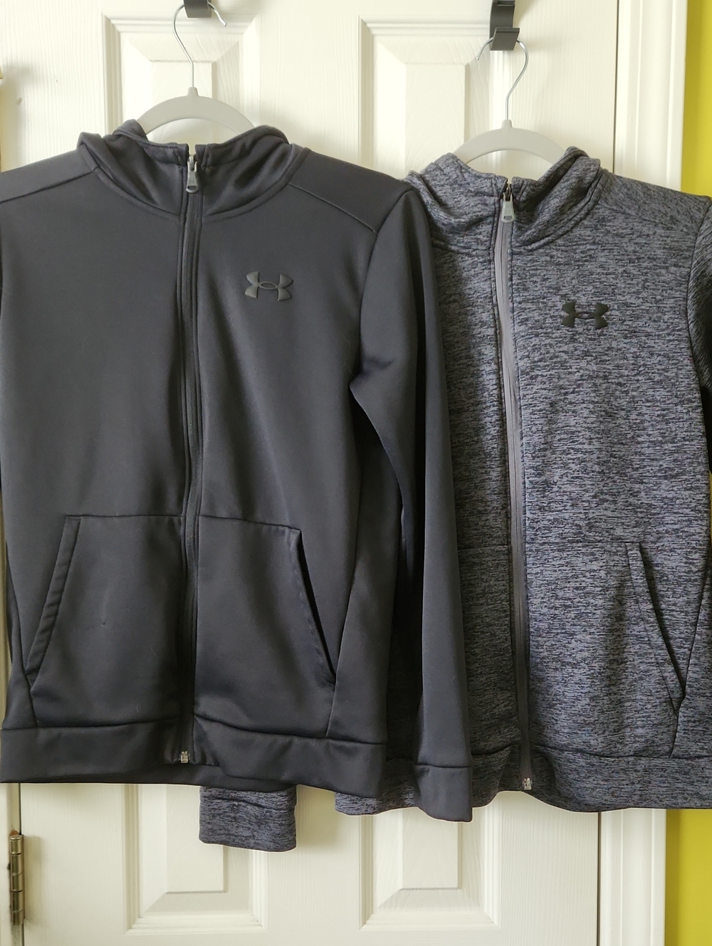 Two Under Armour Kids Full-Zip Hoodies in Black and Heather Gray